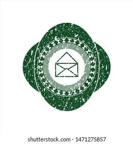 Green envelope icon inside rubber seal with grunge texture