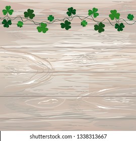 Green festive bunting with clover. Irish holiday - Happy St. Patrick's Day with garland of three-leaf. Greeting card, poster, banner. Vector on wooden background