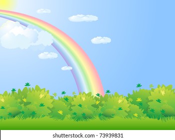Green fields with shrubs vegetation under a cloudy sky with rainbow