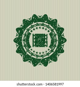 Green film icon inside distress rubber grunge texture seal