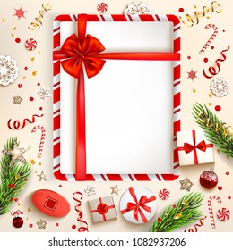 Green fir tree branches on light holiday background. Natural design elements. Festive background with gift boxes
