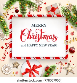 Green fir tree branches on light holiday background. Natural design elements. Festive background with gift boxes and Merry Christmas lettering