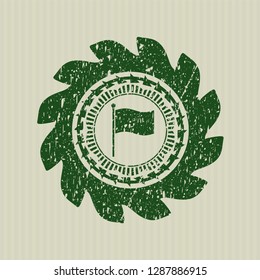 Green flag icon inside distress rubber stamp with grunge texture