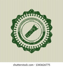 Green flashlight icon inside rubber stamp with grunge texture