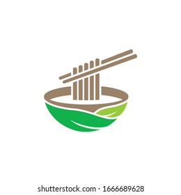 green food logo concept: noodles on green bowl are taken with chopsticks isolated