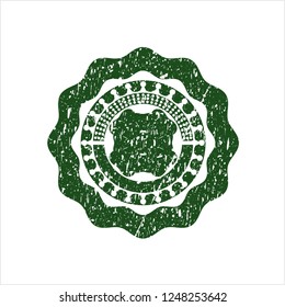 Green four leaf clover icon inside rubber grunge stamp
