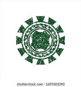 Green four leaf clover icon inside distressed rubber seal with grunge texture