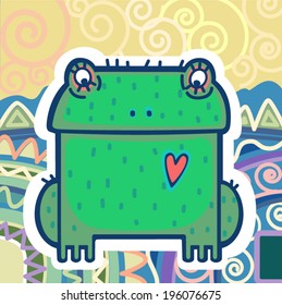 Green frog is sitting on the background of colored mountains.