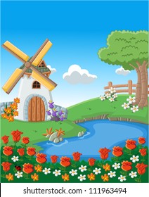 Green garden with colorful beautiful spring flowers, lake and windmill