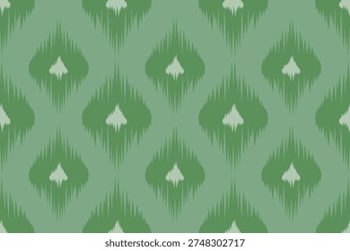 Green geometric diamond ikat pattern with symmetrical repeating shapes, inspired by traditional woven textile design.