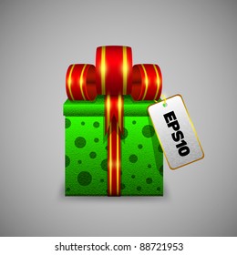 The green gift box with a big red ribbon and sticker