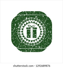 Green gift box icon inside distress rubber seal with grunge texture