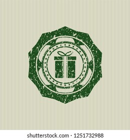 Green gift box icon with rubber seal texture