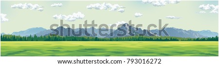 green glade against the background of mountains