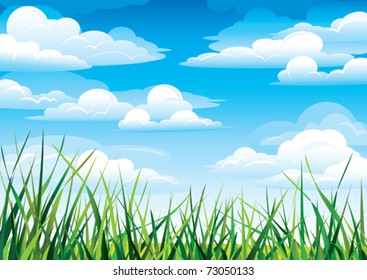 Green grass in a blue sky and clouds