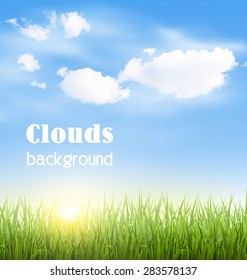 Green grass lawn with clouds and sun on blue sky