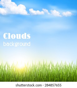 Green grass lawn with clouds and sun on blue sky