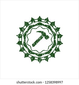 Green hammer icon inside distressed rubber grunge texture seal