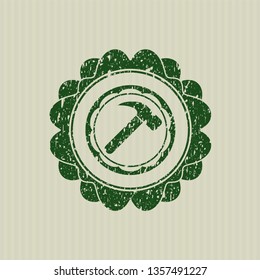 Green hammer icon inside distressed grunge stamp