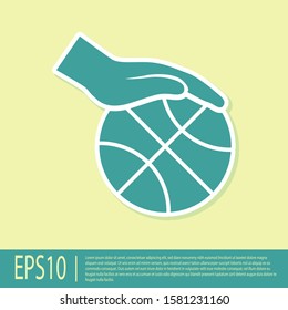 Green Hand with basketball ball icon isolated on yellow background. Sport symbol.  Vector Illustration