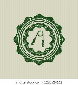 Green hand gripper icon inside rubber stamp with grunge texture
