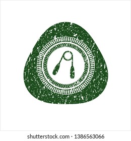 Green hand gripper icon inside rubber grunge seal