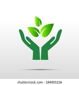 Green hand with green leaf over white background