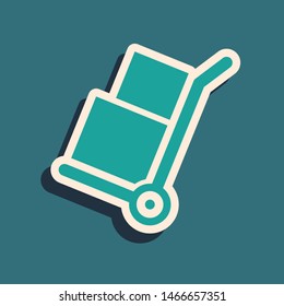 Green Hand truck and boxes icon isolated on blue background. Dolly symbol. Long shadow style. Vector Illustration