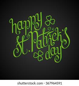 Green hand written St. Patrick's day greetings over black background.