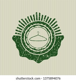 Green hanger icon inside distress grunge style stamp