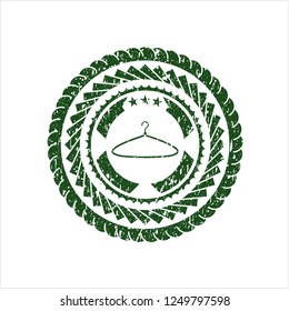 Green hanger icon inside distressed grunge seal