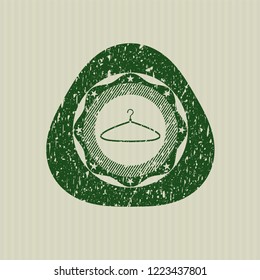 Green hanger icon inside rubber texture