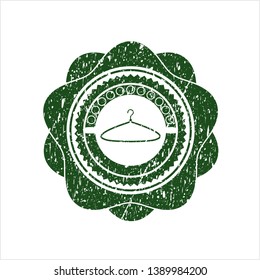 Green hanger icon inside rubber grunge stamp