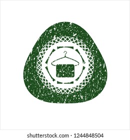 Green hanger with towel icon inside distressed grunge stamp