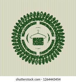 Green hanger with towel icon inside distress rubber stamp