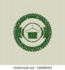 Green hanger with towel icon inside distressed rubber grunge stamp