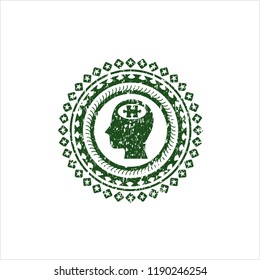 Green head with jigsaw puzzle piece icon inside rubber seal with grunge texture