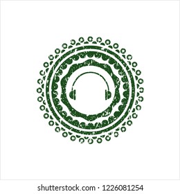 Green headphones icon inside distress rubber grunge stamp