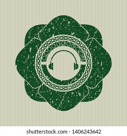 Green headphones icon inside distress grunge stamp