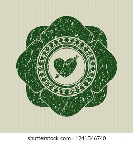 Green heart with arrow icon inside distress with rubber seal texture