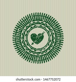 Green heart with arrow icon inside rubber stamp with grunge texture