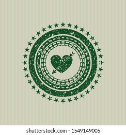 Green heart with arrow icon inside distressed rubber seal with grunge texture