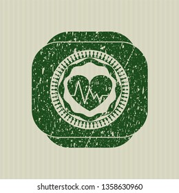 Green heart with electrocardiogram icon inside distressed rubber seal