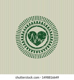 Green heart with electrocardiogram icon inside rubber stamp