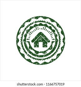 Green home icon inside rubber grunge stamp