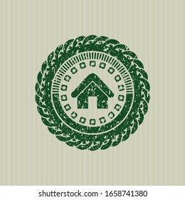 Green home icon inside rubber stamp