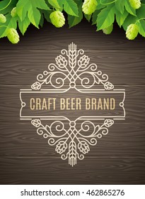 Green hops and flourishes beer emblem on a wooden plank background - vector illustration