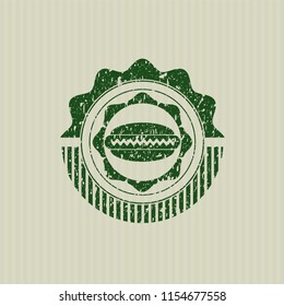 Green hot dog icon inside distressed rubber seal with grunge texture