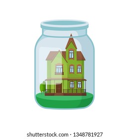 Green house in glass jar on white background.