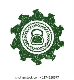 Green kettlebell icon inside rubber grunge texture stamp